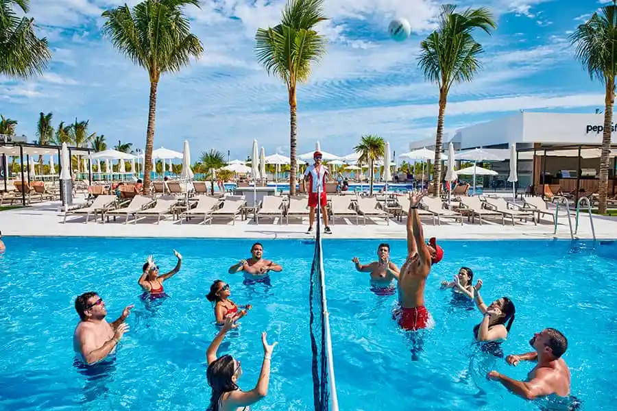 group playing volleyball in the pool