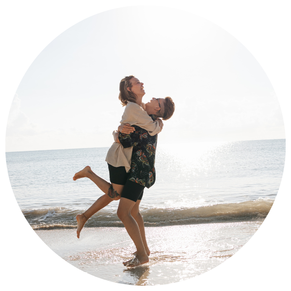 couple playing in the water at beautiful beach