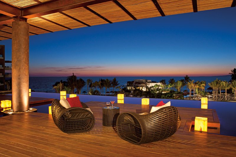 lounge chairs on patio at sunset