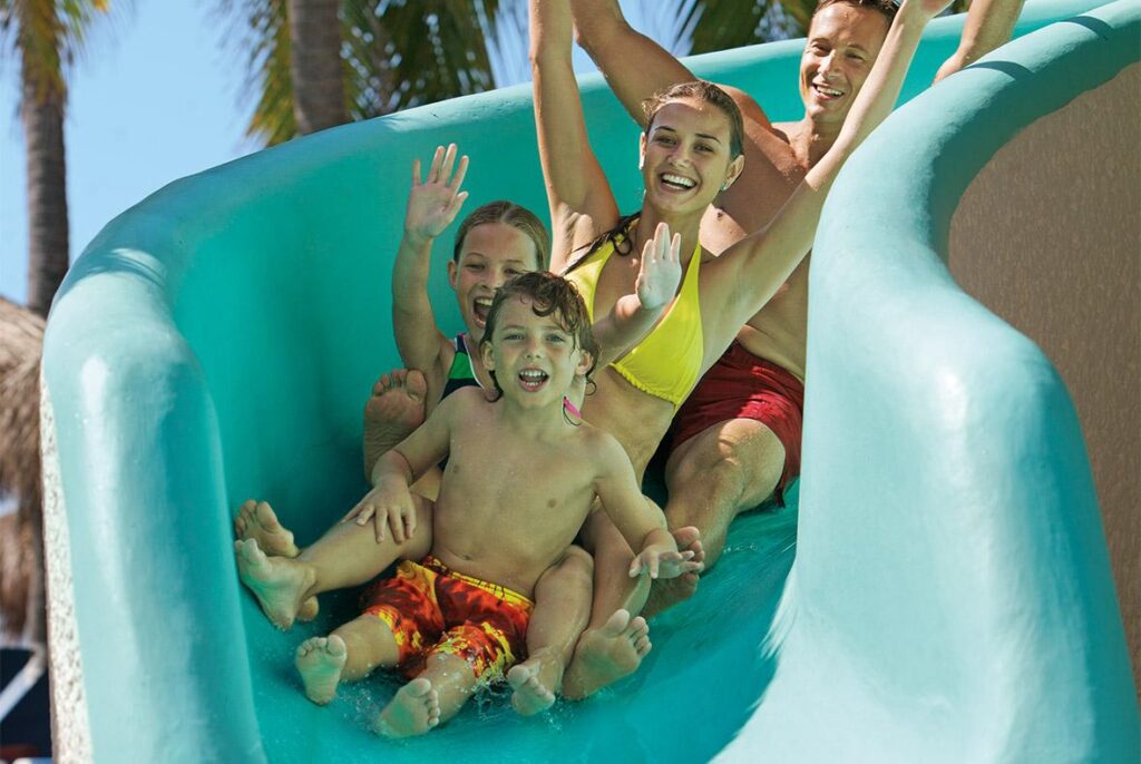 family going down water slide