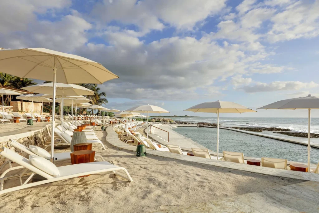 sunloungers on beach at TRS Yucatan Hotel