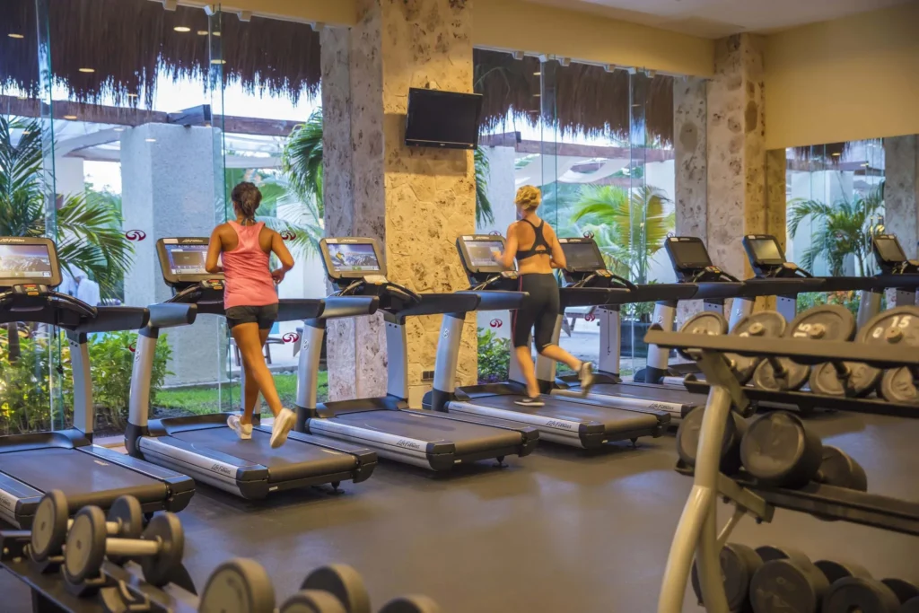 women running on treadmill at TRS Yucatan hotel fitness center