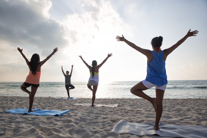 group yoga class on the beach